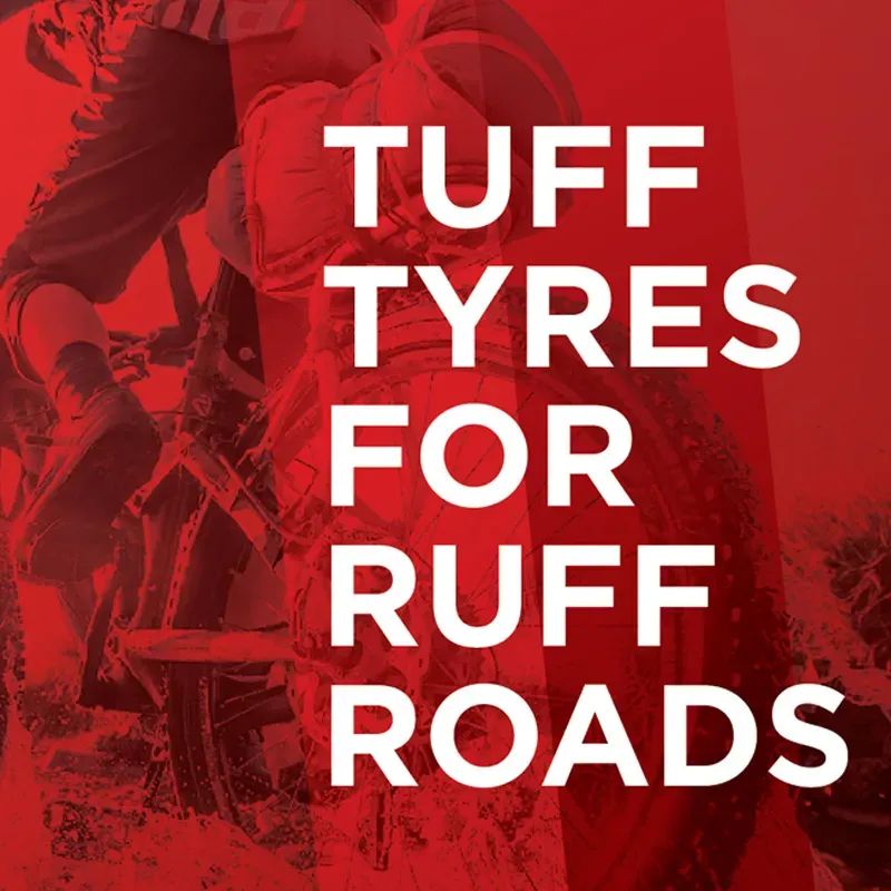 Bedrock Tyres campaign tile: a red-duotone off-road cyclist behind bold white stacked type reading “Tuff tyres for ruff roads”.